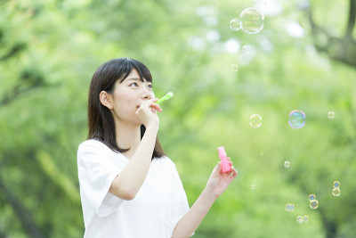 一个女人吹着绿色的肥皂泡