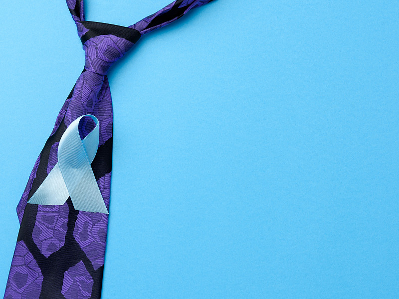 silk purple mens tie and blue ribbon folded in a l