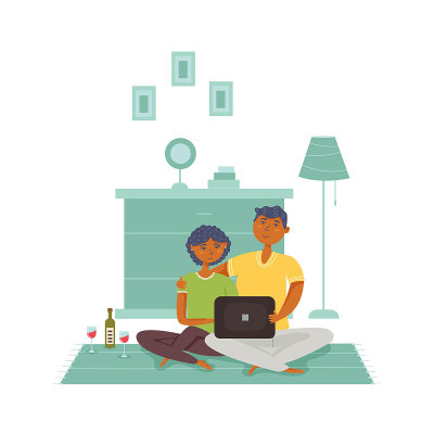 Couple sitting on the floor looking laptop drinkin
