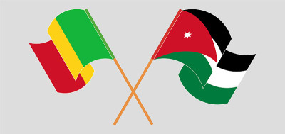 Crossed and waving flags of Mali and Jordan