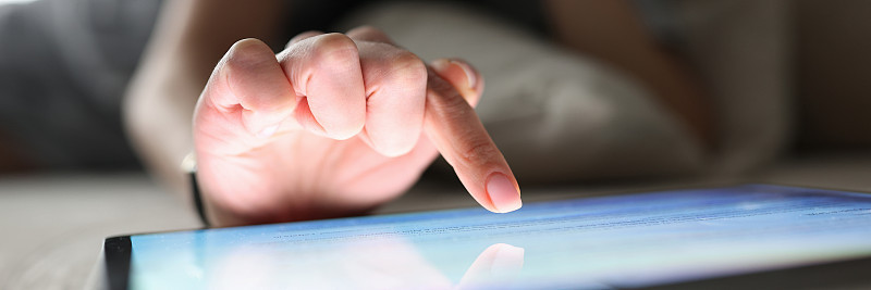 Female finger over the included tablet closeup