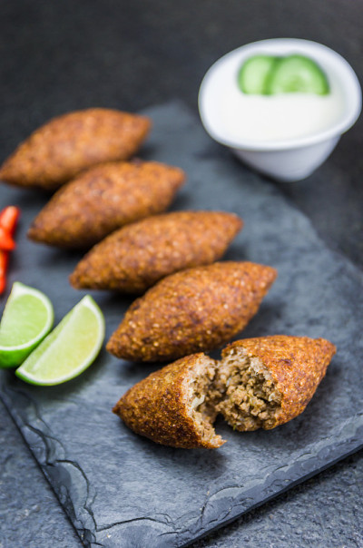 美味的黎巴嫩(阿拉伯)食物，kibbeh (kibe)在黑色板岩和花岗岩背景。
