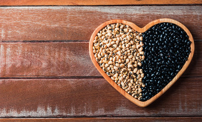 black bean and soybean seeds on a heart plate