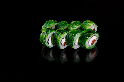 Fresh delicious beautiful sushi rolls on a dark ba