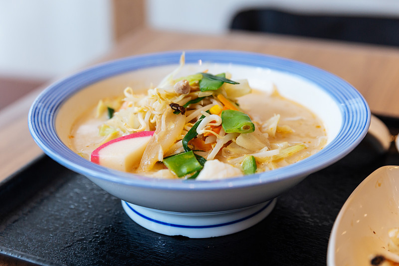 冠军拉面(一种面条，是日本长崎的一种地方美食)，里面有猪肉、虾、葱、芽、胡萝卜、卷心菜、玉米和镰卷子