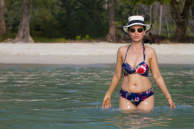 Woman traveler relax on water with sunlight at bea