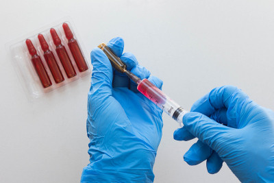 Top view of woman hands in medical gloves filling 