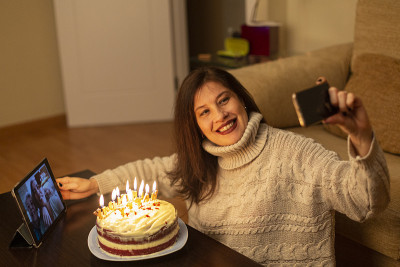 一位女士通过视频电话和家人庆祝她的生日。