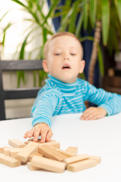 A cute seven-year-old child boy playing games at h