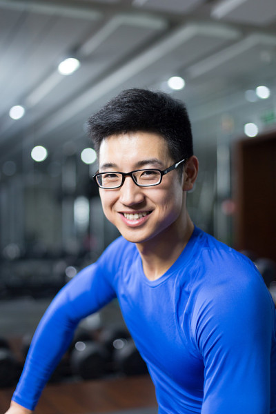 年轻的亚洲人在现代健身房锻炼