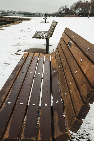 白雪覆盖的公园里空荡荡的长椅