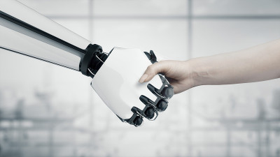 Handshake of a businessman woman and a robot with 