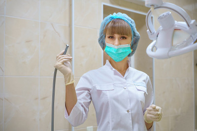 一位女牙医手里拿着一台硼机