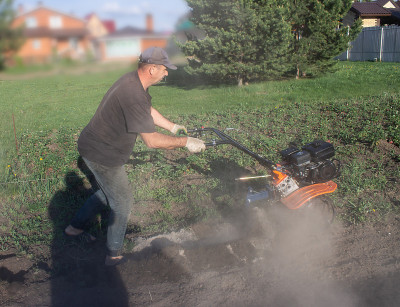A man working in the field - dripping ground the m