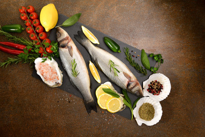 Top view of fresh Sea Bass fish and seafood arrang