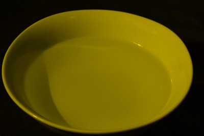 White bowl filled with water on black background