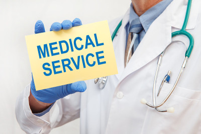 Close-up of a male doctor holding a sign with the 