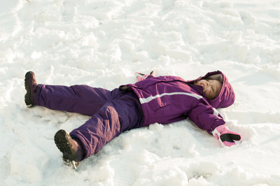 女孩躺在雪地上