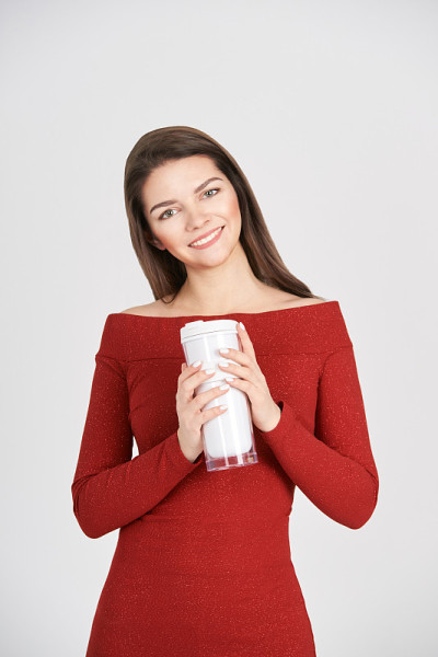 Beautiful girl with coffee tumbler. Takeaway drink