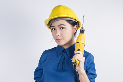 拿着钻头的年轻建筑工人