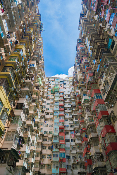 香港市中心鱼涌益发大厦老旧拥挤的公寓中的住宅区。高层建筑，摩天楼与立面窗户的建筑，在城市的中午与蓝天