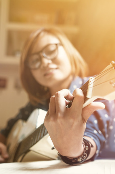 弹吉他的亚洲女孩。