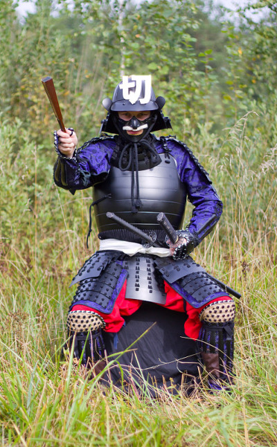 武士用折叠的扇子在盔甲上显示方向