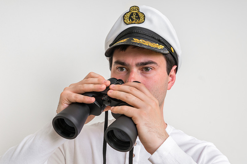 Happy captain holding binoculars