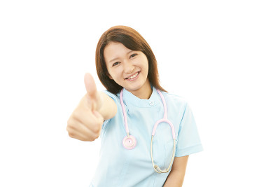 微笑的亚洲女护士竖起大拇指