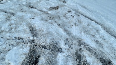 白色的雪地上留下了汽车的车辙