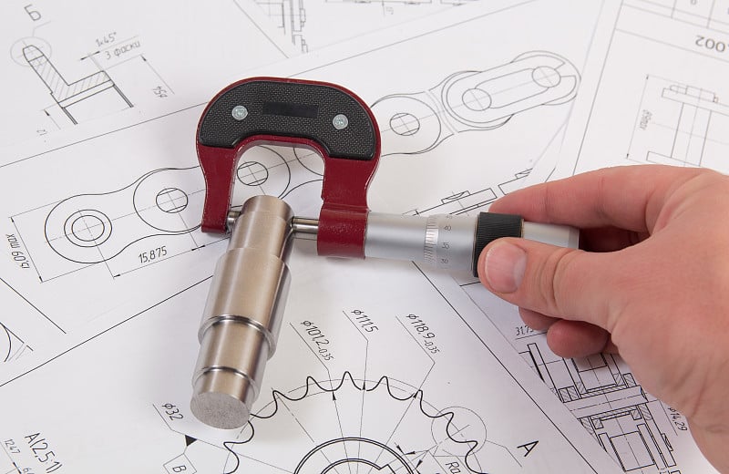 技术图纸、千分尺和传动滚子链。工程，技术和金属加工。产业链细节的千分尺测量。