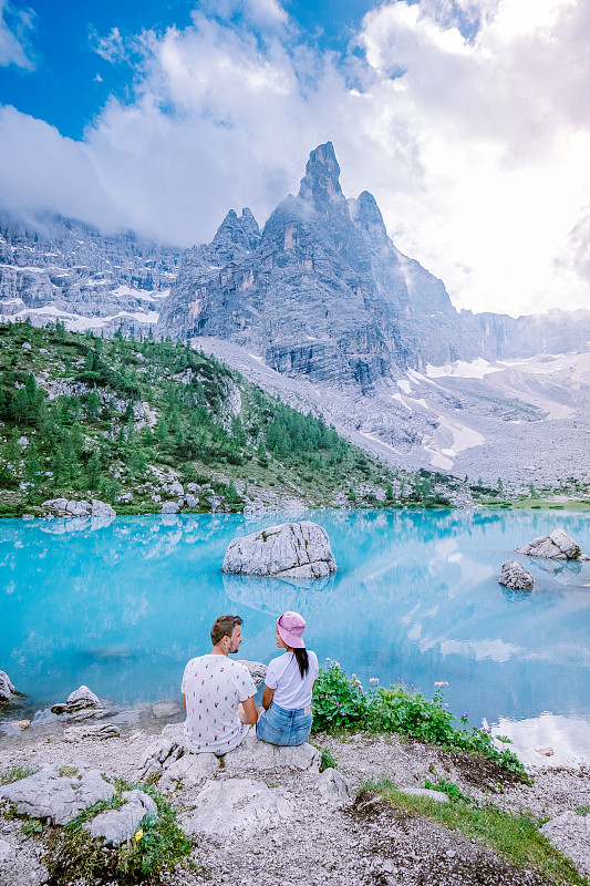 Couple visit the blue green lake in the Italian Do