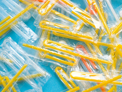 Pile of yellow drinking straws on a blue backgroun