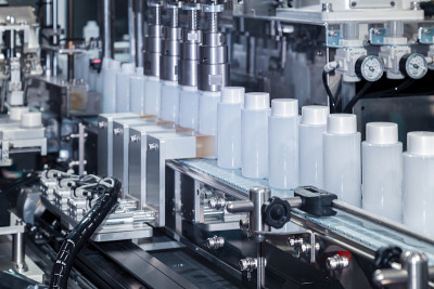 white plastic bottle moving on conveyor belt of au