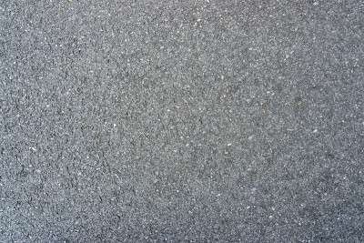 黑色沥青混凝土背景表面粗糙。无缝的灰色的道路。
