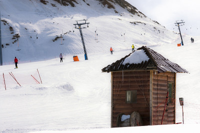 小木屋位于雪山地形中。