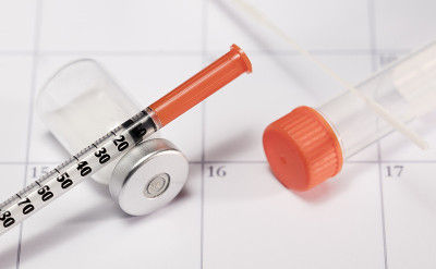 syringe and vaccine vial with SARS COV-2 (covid-19