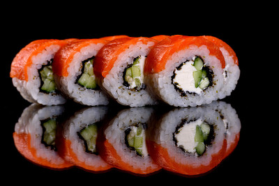 Fresh delicious beautiful sushi rolls on a dark ba