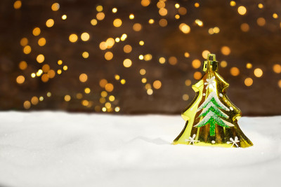 Golden Christmas tree on the snow with New Year's 