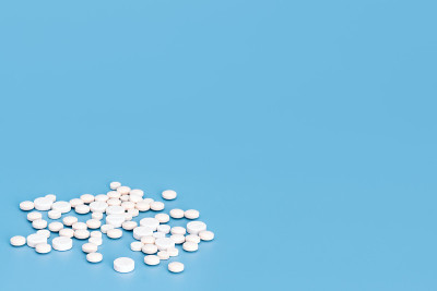 Tablets.    A lot of white pills are scattered on 