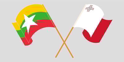 Crossed and waving flags of Myanmar and Malta