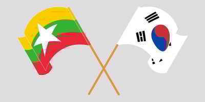 Crossed and waving flags of Myanmar and South Kore