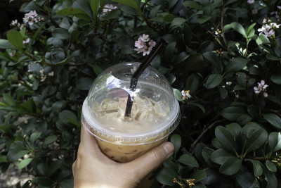 Hand on iced coffee drink