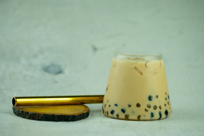 一小杯冰奶茶和珍珠与金色吸管