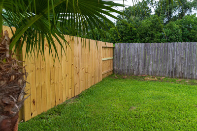 Wooden privacy fence, new and old in the same yard