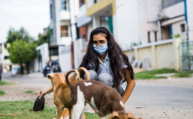 girl playing with puppies