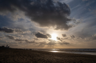 Winter walking on wide sandy beach of North sea ne