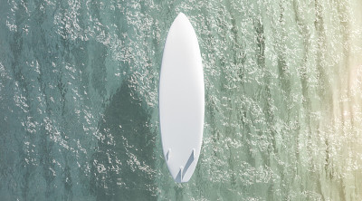 Blank white surfboard with fins on water surface m