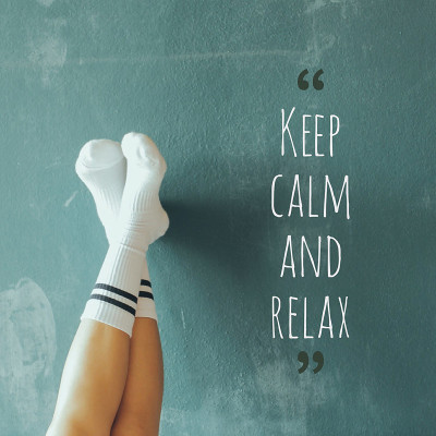 脚放在墙上，上面写着:â保持冷静，relaxâ