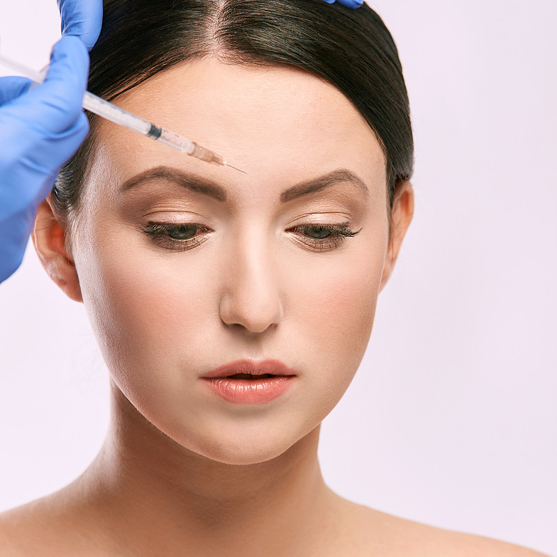 Face needle injection. Young woman cosmetology pro